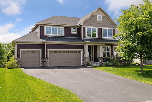 3751 Crane Island Ct, Minnetrista, MN 55331 - craftsman inspired home featuring driveway, stone siding, a front yard, and a shingled roof