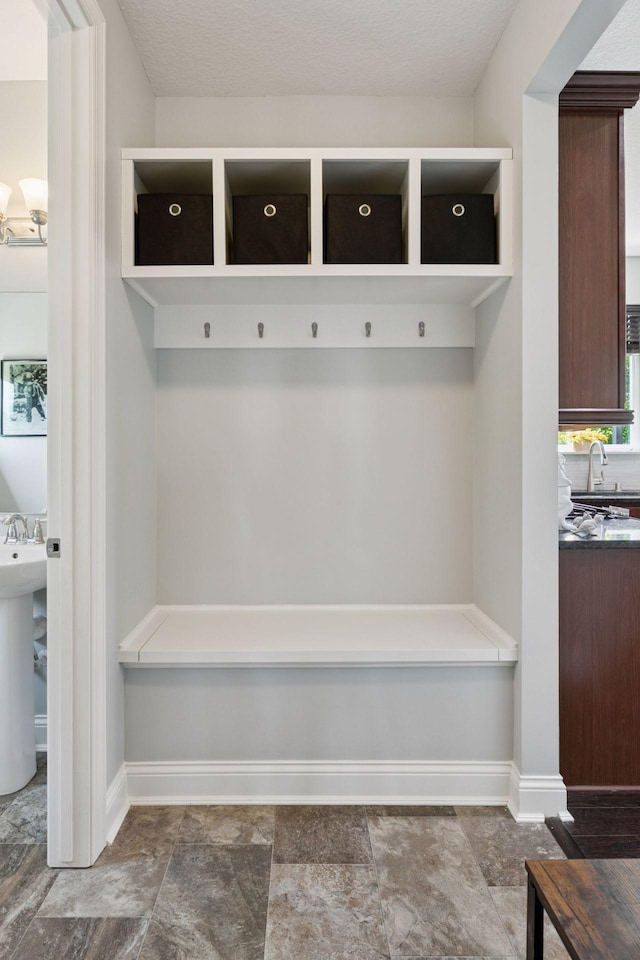3751 Crane Island Ct, Minnetrista, MN 55331 - mudroom with baseboards, a sink, and stone finish flooring