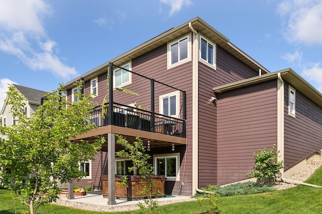 3751 Crane Island Ct, Minnetrista, MN 55331 - rear view of house with a hot tub, a deck, a lawn, and a patio