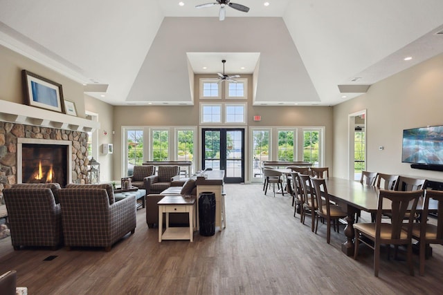 3751 Crane Island Ct, Minnetrista, MN 55331 - living room featuring a ceiling fan, high vaulted ceiling, wood finished floors, a fireplace, and recessed lighting