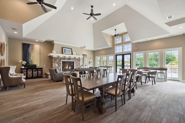 3751 Crane Island Ct, Minnetrista, MN 55331 - dining room featuring a ceiling fan, high vaulted ceiling, a stone fireplace, wood finished floors, and recessed lighting