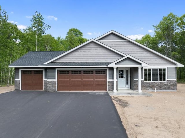 TBD Lynndale Dr, Baxter, MN 56401 - view of front of property featuring stone siding, asphalt driveway, and an attached garage