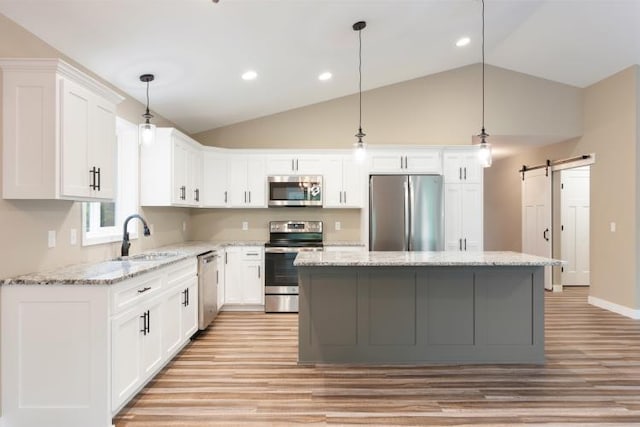 TBD Lynndale Dr, Baxter, MN 56401 - kitchen with stainless steel appliances, a sink, light wood-style flooring, vaulted ceiling, and a kitchen island
