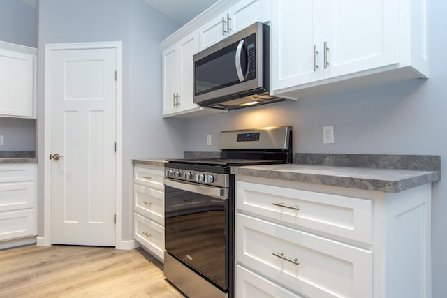 TBD Lynndale Dr, Baxter, MN 56401 - kitchen with stainless steel appliances, light wood finished floors, white cabinets, and dark countertops