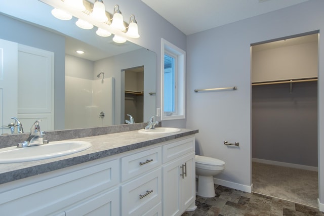 TBD Lynndale Dr, Baxter, MN 56401 - bathroom with a walk in closet, a walk in shower, double vanity, toilet, and baseboards