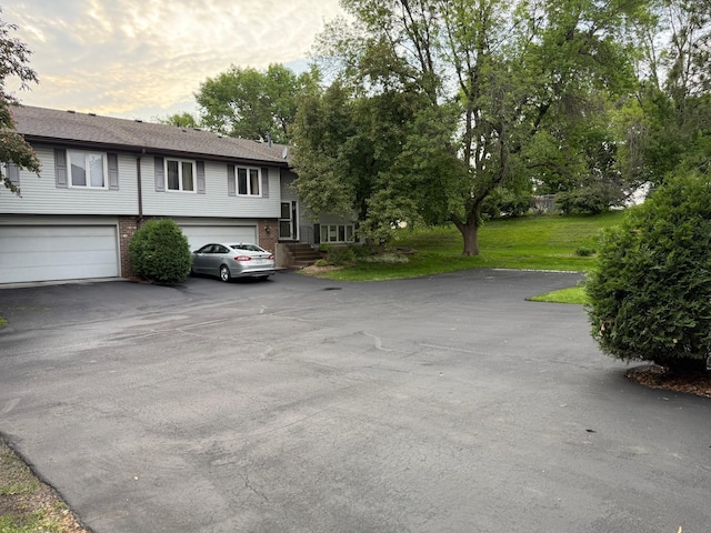 14410 92nd Ave N, Maple Grove, MN 55369 - view of front of home with driveway, a garage, and brick siding