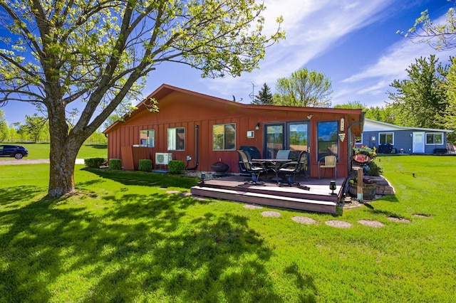 3865 Wahtomin Trl NW, Alexandria, MN 56308 - back of property with a wooden deck, a yard, and board and batten siding