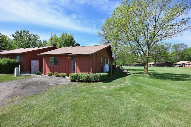 3865 Wahtomin Trl NW, Alexandria, MN 56308 - view of property exterior featuring a lawn and board and batten siding