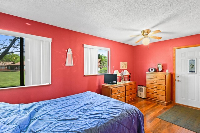 3865 Wahtomin Trl NW, Alexandria, MN 56308 - bedroom with wood finished floors, a textured ceiling, and a ceiling fan