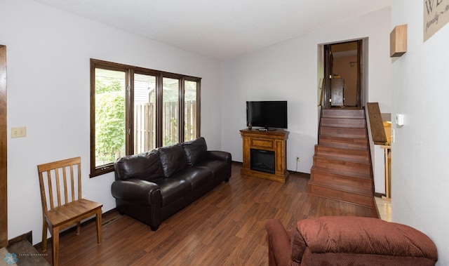 1427 23rd St S, Fargo, ND 58103 - living area featuring wood finished floors, a glass covered fireplace, vaulted ceiling, and stairway