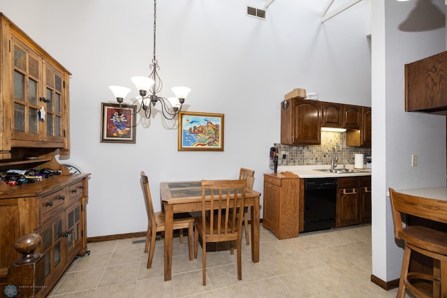 1427 23rd St S, Fargo, ND 58103 - dining room featuring a chandelier, a high ceiling, light tile patterned floors, and baseboards