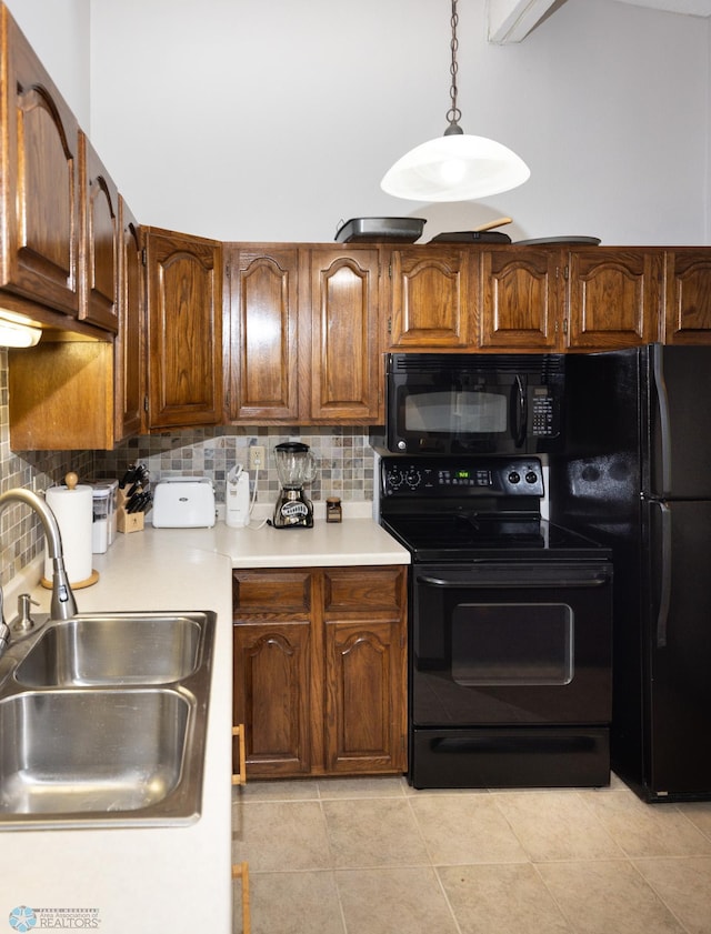1427 23rd St S, Fargo, ND 58103 - kitchen featuring black appliances, a sink, backsplash, light countertops, and pendant lighting
