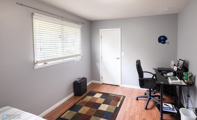 1427 23rd St S, Fargo, ND 58103 - office area with wood finished floors, a textured ceiling, and baseboards