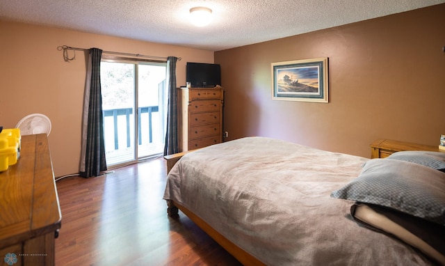 1427 23rd St S, Fargo, ND 58103 - bedroom with access to outside, wood finished floors, and a textured ceiling