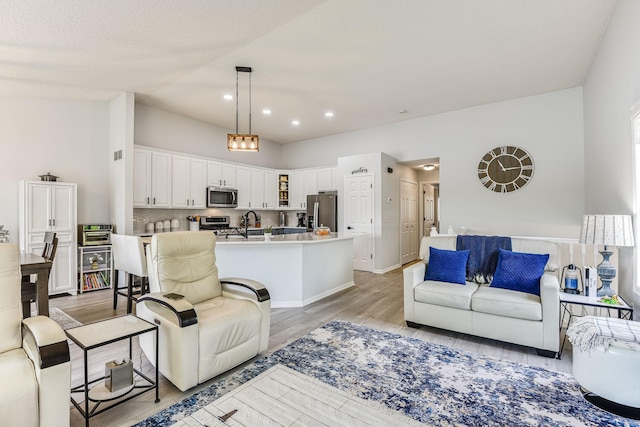 11001 Isanti Ct NE, Blaine, MN 55449 - living room with light wood-type flooring and recessed lighting