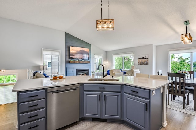 11001 Isanti Ct NE, Blaine, MN 55449 - kitchen with stainless steel dishwasher, open floor plan, a sink, light countertops, and lofted ceiling