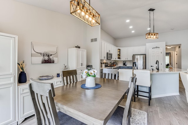 11001 Isanti Ct NE, Blaine, MN 55449 - dining space with light wood-style floors, a chandelier, and recessed lighting