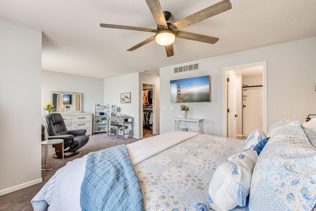 11001 Isanti Ct NE, Blaine, MN 55449 - carpeted bedroom featuring a walk in closet, a textured ceiling, ceiling fan, a closet, and ensuite bathroom