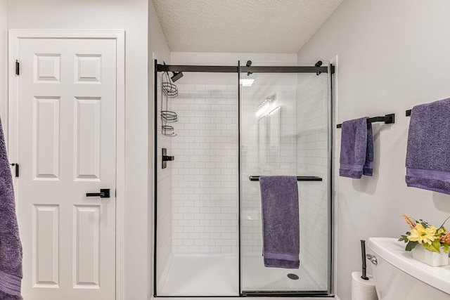 11001 Isanti Ct NE, Blaine, MN 55449 - bathroom with toilet, a shower stall, and a textured ceiling