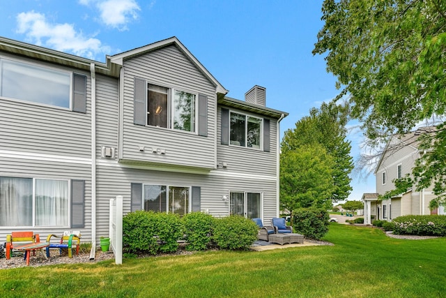 11001 Isanti Ct NE, Blaine, MN 55449 - back of house with a yard and a chimney