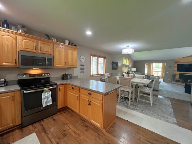 1209 23rd St SE, Willmar, MN 56201 - kitchen with appliances with stainless steel finishes, open floor plan, healthy amount of natural light, recessed lighting, and wood finished floors