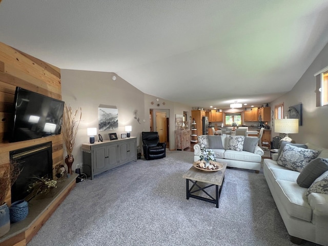 1209 23rd St SE, Willmar, MN 56201 - living room with light carpet, a large fireplace, wood walls, and lofted ceiling