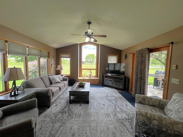1209 23rd St SE, Willmar, MN 56201 - carpeted living area featuring vaulted ceiling, ceiling fan, and healthy amount of natural light