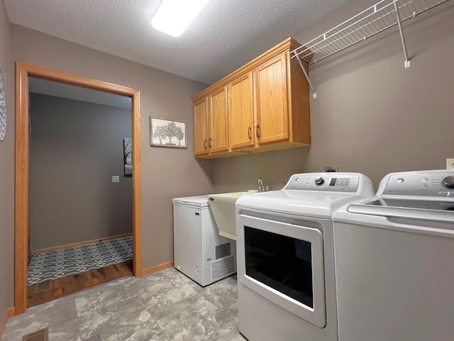 1209 23rd St SE, Willmar, MN 56201 - laundry room featuring cabinet space, washer and clothes dryer, and baseboards
