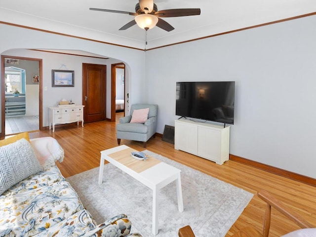 1033 Hall Ave W, Saint Paul, MN 55118 - living room featuring arched walkways, ceiling fan, and light wood-style flooring
