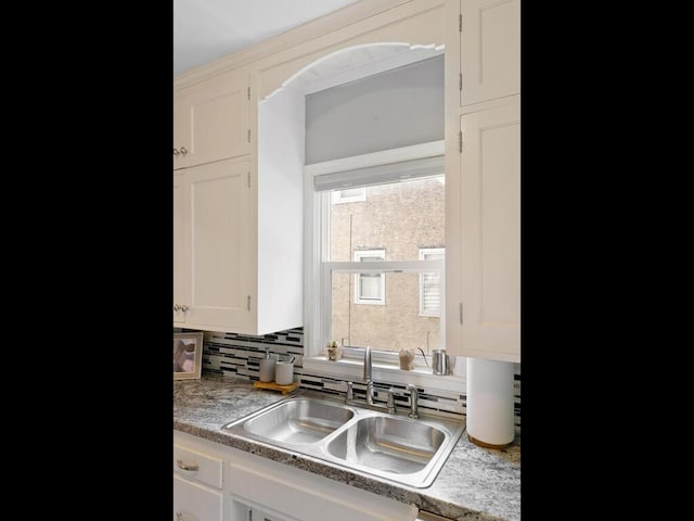 1033 Hall Ave W, Saint Paul, MN 55118 - kitchen with a sink, decorative backsplash, white cabinetry, and light countertops