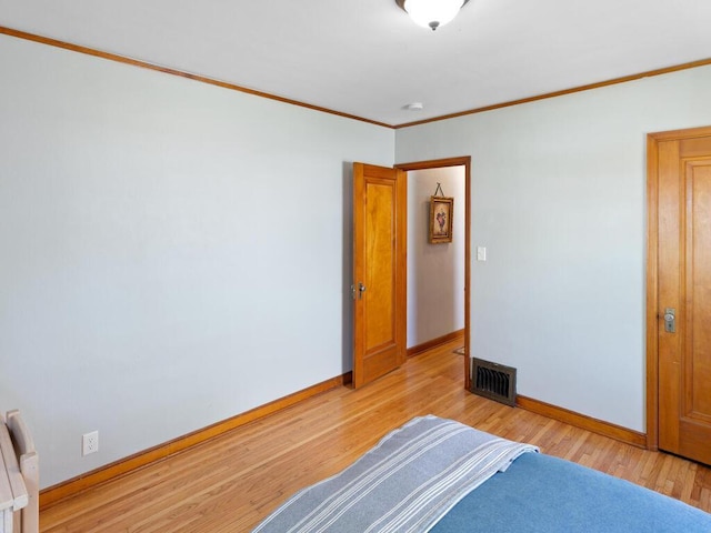 1033 Hall Ave W, Saint Paul, MN 55118 - bedroom with baseboards, light wood-style flooring, and crown molding