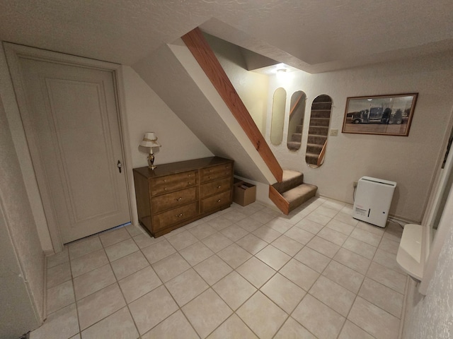 620 5th Ave SE, Pipestone, MN 56164 - bedroom featuring light tile patterned floors and a textured ceiling