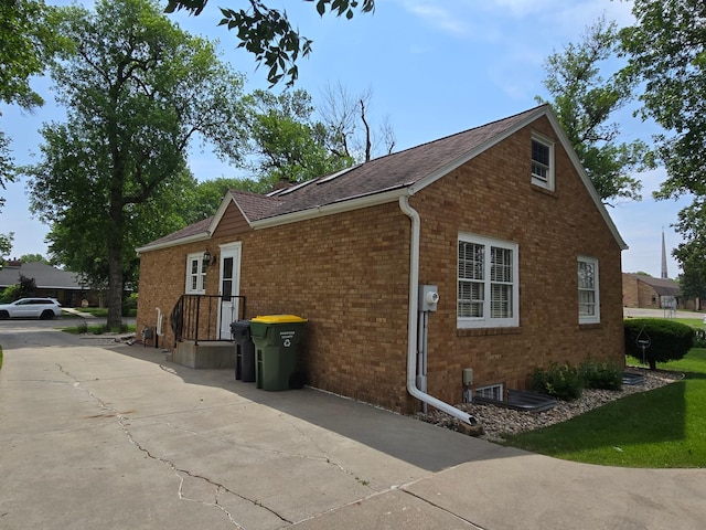 620 5th Ave SE, Pipestone, MN 56164 - view of side of property featuring brick siding and a shingled roof
