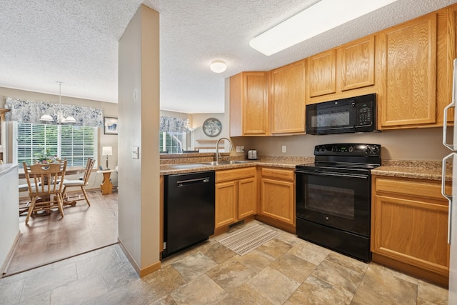 15548 Float Ln Unit 104, Apple Valley, MN 55124 - kitchen with black appliances, a sink, light countertops, a chandelier, and a textured ceiling