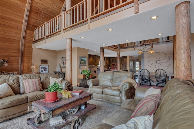 2917 Vonderheide Dr SW, Alexandria, MN 56308 - living area featuring decorative columns, a towering ceiling, recessed lighting, and wooden walls