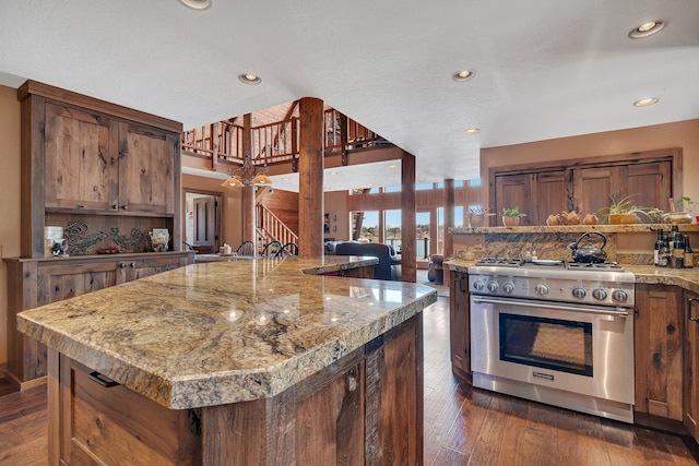 2917 Vonderheide Dr SW, Alexandria, MN 56308 - kitchen featuring high end stove, dark wood-style floors, recessed lighting, light stone countertops, and brown cabinets