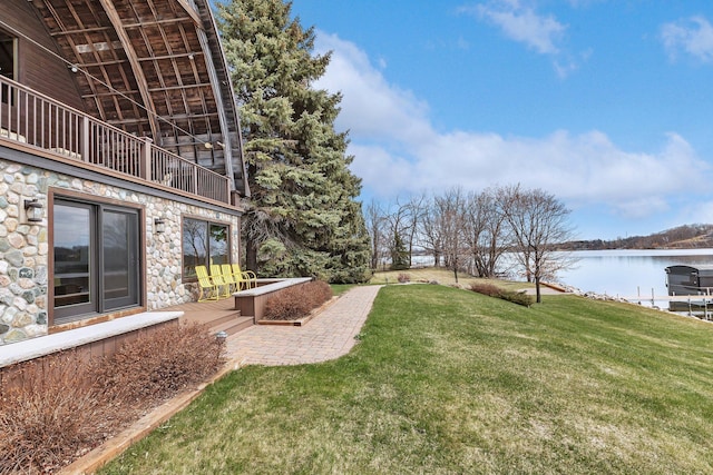 2917 Vonderheide Dr SW, Alexandria, MN 56308 - view of green lawn with a water view, a balcony, and a patio