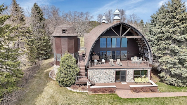 2917 Vonderheide Dr SW, Alexandria, MN 56308 - rear view of property with a balcony, stone siding, and a lawn