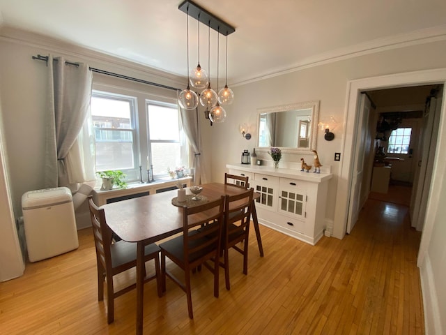 3112 Bryant Ave S Unit 1, Minneapolis, MN 55408 - dining area with crown molding, light wood-style floors, and plenty of natural light