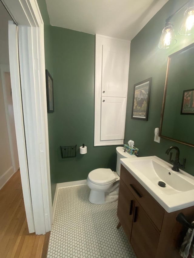 3112 Bryant Ave S Unit 1, Minneapolis, MN 55408 - bathroom with vanity, toilet, wood finished floors, and baseboards