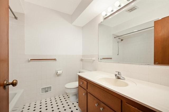 1624 Saint Croix Cir, Golden Valley, MN 55422 - bathroom with toilet, vanity, tile walls, wainscoting, and bathing tub / shower combination