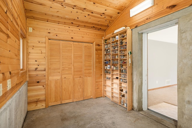 1624 Saint Croix Cir, Golden Valley, MN 55422 - unfurnished bedroom featuring wood walls, vaulted ceiling, concrete flooring, and a closet