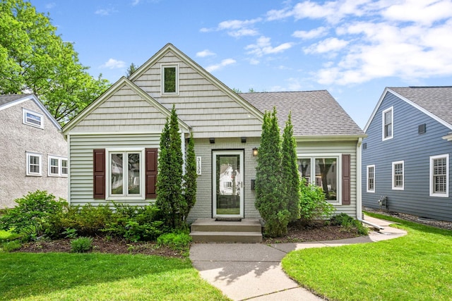 3139 Cleveland St NE, Minneapolis, MN 55418 - view of front of home with a front yard and a shingled roof