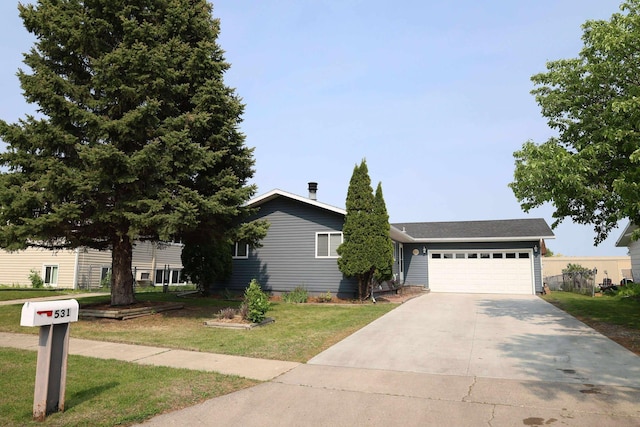 531 5th Street Ct E, West Fargo, ND 58078 - view of front of home featuring a front yard, concrete driveway, and a garage