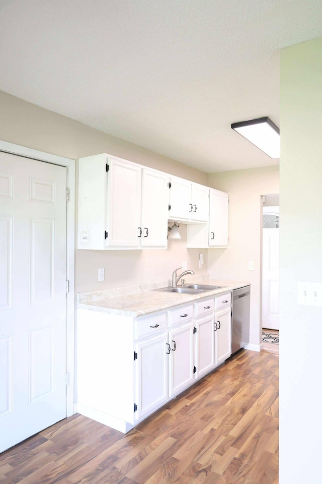 531 5th Street Ct E, West Fargo, ND 58078 - kitchen with dishwasher, light wood-style floors, and white cabinets