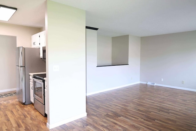 531 5th Street Ct E, West Fargo, ND 58078 - kitchen with stainless steel electric stove, wood finished floors, white cabinets, and baseboards