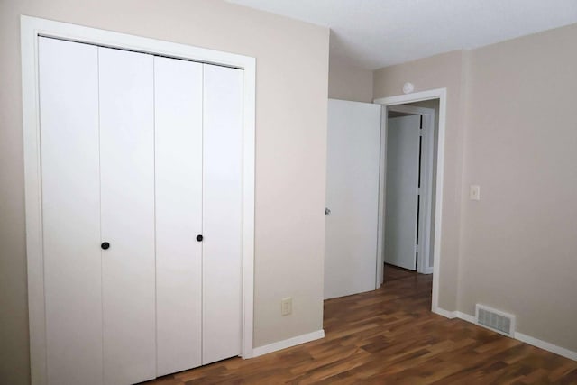 531 5th Street Ct E, West Fargo, ND 58078 - unfurnished bedroom with wood finished floors, baseboards, and a closet