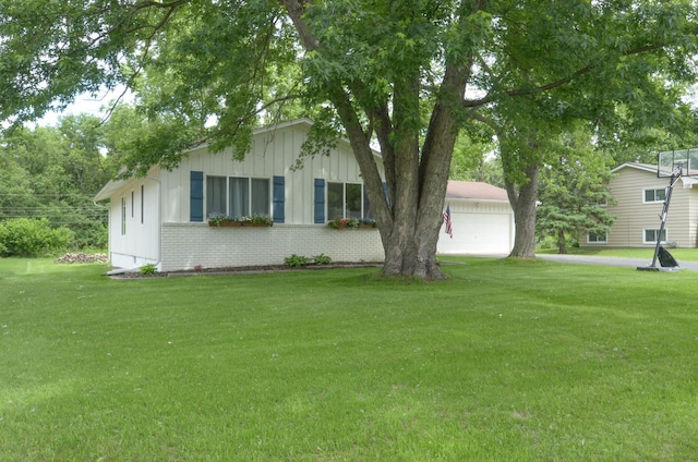 2603 140th Ln NW, Andover, MN 55304 - view of front facade featuring board and batten siding, a front lawn, brick siding, and a garage