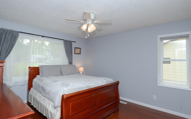 2603 140th Ln NW, Andover, MN 55304 - bedroom with dark wood finished floors, a textured ceiling, and a ceiling fan