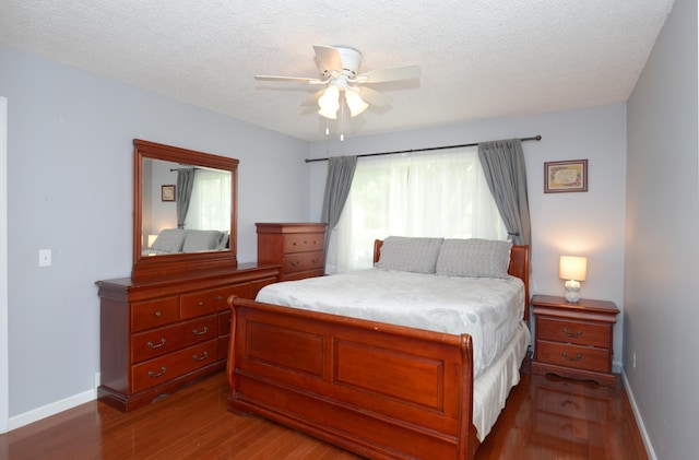 2603 140th Ln NW, Andover, MN 55304 - bedroom featuring dark wood-style flooring, a ceiling fan, and a textured ceiling